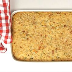 a casserole dish is shown with a red and white checkered cloth next to it