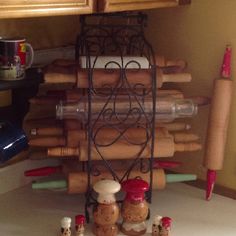 there are many different items on the shelf in this kitchen, including wine bottles and corkscrews