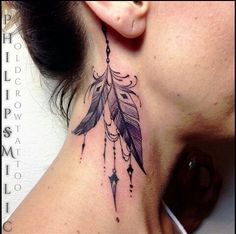 a woman with a tattoo on her neck has a feather and beads hanging from it