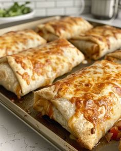 several pieces of pizza sitting on top of a baking pan covered in cheese and toppings