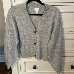 Brand New, Never Worn. Grey With Brown/Tortoise Buttons. Very Soft Material. Balloon Sleeves. Casual H&m V-neck Cardigan, H&m Long Sleeve Fall Cardigan, H&m Long Sleeve Cardigan For Fall, H&m V-neck Fall Outerwear, Coral Cardigan, White Knit Cardigan, Cream Colored Sweater, Basic Cardigan, Color Block Cardigan