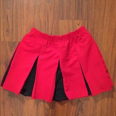 Red And Black Cheerleader Skirt. Thick Material Holds Its Shape. Size Medium. Elastic Waistband Hits At The Waist. Brand New! Red Skort For School In Spring, Red Mini Skirt For School In Summer, Red Pleated Short Tennis Skirt, Red Mini Tennis Skirt For School, Red Lined Mini Tennis Skirt, Casual Red Tennis Skirt For School, Stretch Red Lined Tennis Skirt, Stretch Red Tennis Skirt With Lining, Casual Red Skort For School