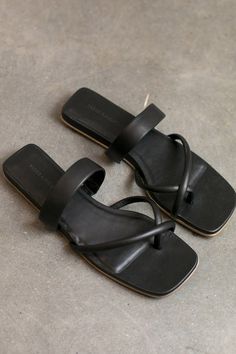 The mari giudicelli travel sandal in black will be a warm weather staple in your wardrobe for seasons to come. complete with minimal yet unique strapping; one that holds the middle of your foot and two rounded straps that cross at the toe.    details:    - color: black  - 100% leather  - square toe; square heel  - made in brazil  - we recommend taking the next size up Black Leather Waterproof Sandals, Modern Black Leather Footbed Sandals, Sleek Black Square Toe Sandals, Black Leather Low-top Sandals, Black Leather Slides For Beach, Mari Giudicelli, Travel Sandals, Block Heel Loafers, Minimal Accessories