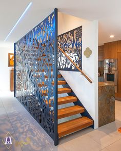 a stair case in the middle of a room with wooden steps and metal railings