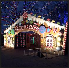 a large gingerbread house decorated with lights and candy canes