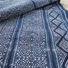 a blue and white rug on the ground