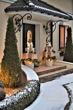 a house decorated for christmas with trees and candles