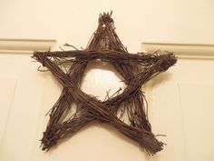 a star made out of twigs sitting on top of a door