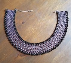 Black & Lilac Two Tone Netting Collar Necklace This Necklace is made with Miyuki seed beads in the following colour: black and lined lilac The Necklace is 340 mm around the inside of the collar excluding the clasp, length can be slightly adjustable due to the extender chain. There is a Lobster clasp and extender chain. Purple Beaded Necklace With Round Black Beads, Purple Necklace With Black Beads, Purple Beaded Choker With Round Beads, Egyptian Collar, Beaded Collar Necklace, Detailed Necklace, Crystal Bead Necklace, Beaded Collar, Swarovski Crystal Earrings