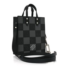 This is an authentic LOUIS VUITTON Damier Graphite Sac Plat XS in Black. This stylish tote is finely crafted of cowhide leather with a damier checkerboard pattern in black and grey. It features top handles and an adjustable strap, the top is open to a black fabric interior. Checkerboard Pattern, Authentic Louis Vuitton, Black Fabric, Cowhide Leather, Louis Vuitton Damier, Adjustable Straps, Black And Grey, Handles, Louis Vuitton