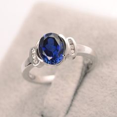 a blue ring sitting on top of a white box