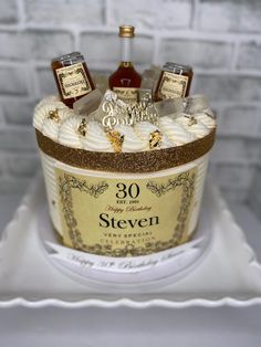 there is a cake made to look like an ice bucket with liquor bottles on it