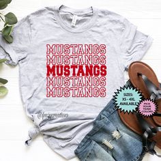 CHEER ON YOUR TEAM in style with this cute Mustangs shirt. Perfect for all sporting events and casual Fridays! Is this not your team?!? Search our other teams here: https://www.etsy.com/shop/FromMe2YouCreations?ref=seller-platform-mcnav§ion_id=24466049 STILL DON'T SEE YOUR TEAM?!? Purchase our custom listing here: https://www.etsy.com/listing/711774236 ►RETURN POLICY **All FM2Y shirts are custom, made to order, and handmade; therefore, they are non refundable. ORDERS that are wrong due to a FM2Y Sporty Graphic Print Shirt For Football Season, Sporty Screen Print Shirt For College, Athletic Heather Letter Print Top For College, Athletic Heather College Top With Letter Print, College Athletic Heather Top With Letter Print, Athletic Heather Tops With Letter Print For College, School Spirit Sports Shirt In Cotton, School Spirit Tops With Letter Print For Sports Season, School Spirit Tops With Name Print For Sports Events