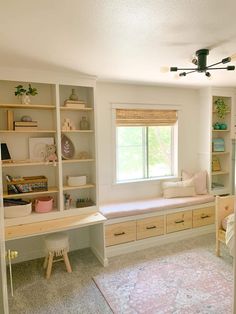 a bedroom with built - in bookshelves, desks and drawers is shown