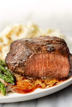 a piece of steak and asparagus on a plate