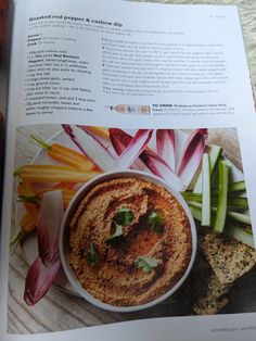 an open book with pictures of food on the page and in it's center