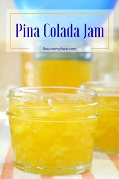 two jars filled with yellow liquid sitting on top of a table