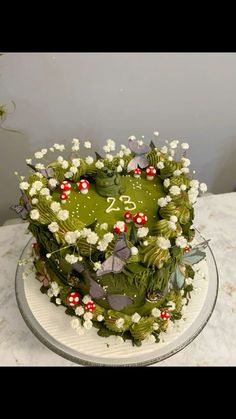 a green cake with white flowers and numbers on it