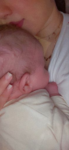 a close up of a person holding a baby