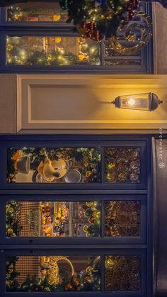 a lighted display case filled with christmas decorations