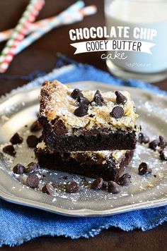 two chocolate chip gooey butter brownies on a plate next to a glass of milk