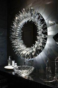 a bathroom sink with a circular mirror above it