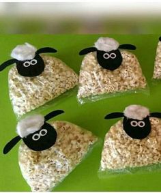 sheep made out of rice krispy treats on a green plate with black and white eyes