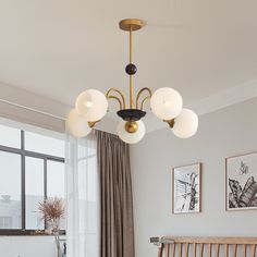 a living room with a couch, table and lamp hanging from it's ceiling