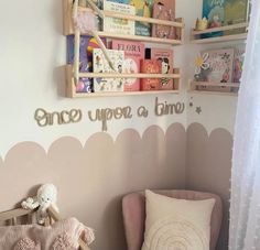 a child's room with pink and white decor