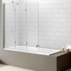 a bath tub sitting next to a white tiled wall with a red sale tag on it