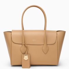 Large tote bag from Salvatore Ferragamo in camel-coloured grained calfskin featuring two top handles, a front flap with lettering logo, an internal flat zipped pocket, a gold-tone plaque charm and gold-tone metal hardware. Composition: 100% Leather Ferragamo Bag, Lettering Logo, Colored Leather, Camel Color, Large Tote Bag, Medium Bags, Womens Tote, Large Tote, Leather Tote Bag