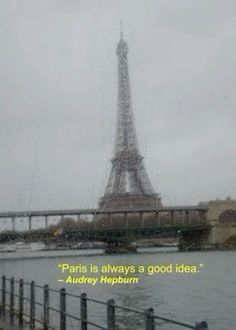 the eiffel tower in paris is seen through a rain soaked window with an inspirational quote