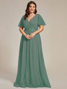 a woman in a long green dress with short sleeves and a v - neckline