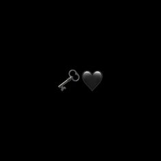 two keys in the shape of a heart on a black background