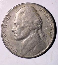 an image of a silver coin on a white surface