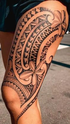 a woman's leg with an intricate tattoo design on the thigh and lower half