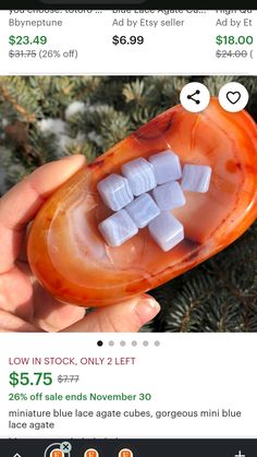 someone is holding an orange and white object with cubes in it's mouth