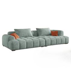 a blue couch with orange pillows on the armrests and an ottoman that is shaped like a reclining sofa