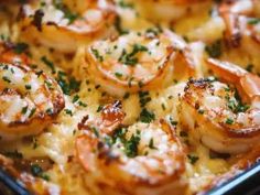 a casserole dish with shrimp and cheese