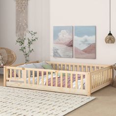 a baby's room with two paintings on the wall and a crib in the foreground