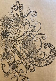 a drawing of flowers and swirls on a piece of paper