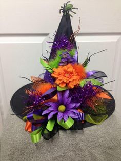 a witches hat with purple and orange flowers