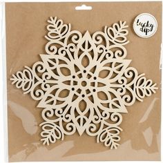 a white paper snowflake cutout on top of a brown package with the words lucky dip