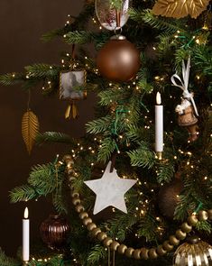 a decorated christmas tree with candles and ornaments