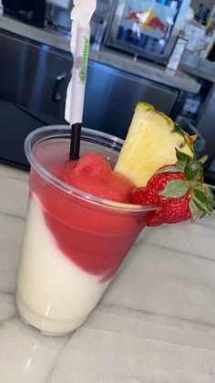 a drink with strawberries and pineapple on the side