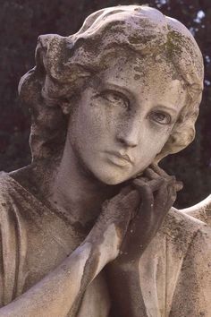 a close up of a statue of a woman with her hand on her chin and looking off into the distance