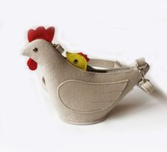 a stuffed chicken in a purse on a white background