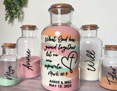 there are three glass jars with writing on them