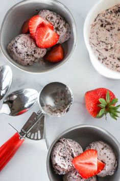 two bowls filled with ice cream and strawberries