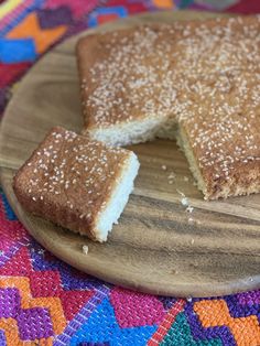 a wooden plate topped with a piece of cake